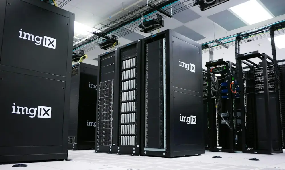 Rows of black server racks with white logos in a data center, illustrating IT foundations